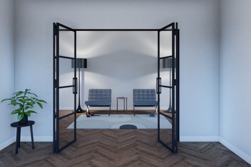 Skyvedør i svart metall med glass – plassbesparende løsning for moderne industrielle interiører.