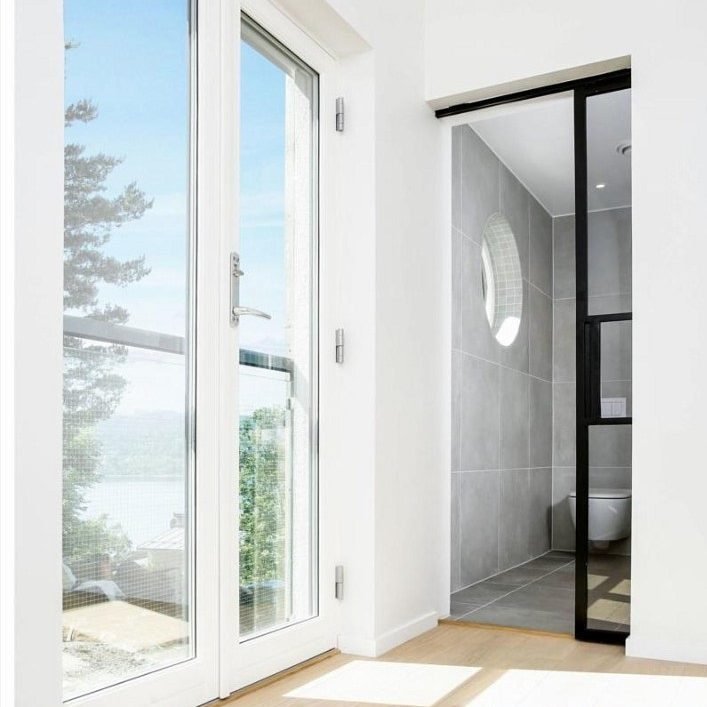 Innebygd-enkel-skyvedør-i-metall-og-glass-som-skiller-bad-og-soverom